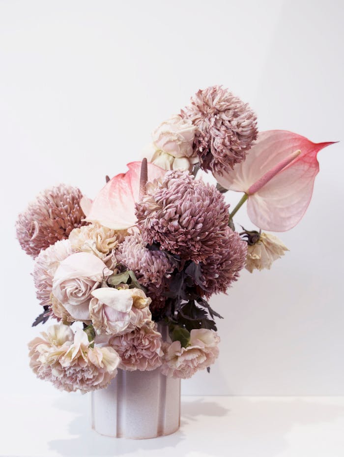A classic arrangement of pink dried flowers captured in a soft, muted light.